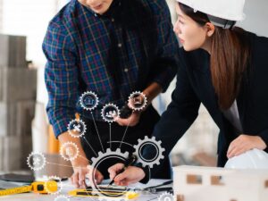 Two workers utilize construction efficiency tools