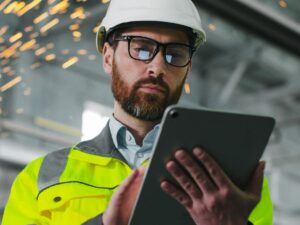 A virtual PMO for construction uses tools during an on-site visit.