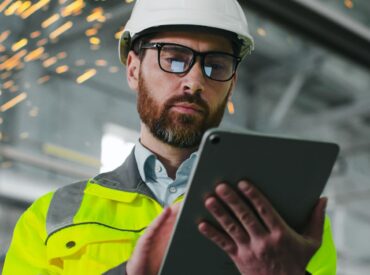 A virtual PMO for construction uses tools during an on-site visit.